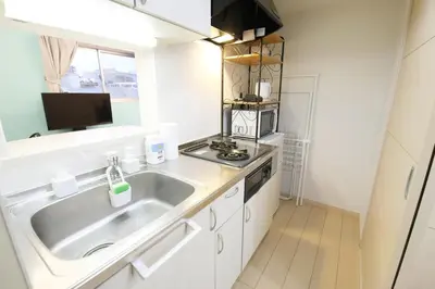 a small kitchen with a sink and a microwave at Sakura Court Ebisu 501 in Tokyo