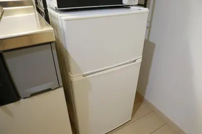 a white refrigerator with a microwave on top of it at Sakura Court Ebisu 501 in Tokyo