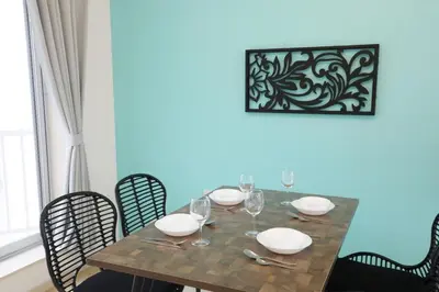 a dining room table with glasses and plates on it at Sakura Court Ebisu 501 in Tokyo