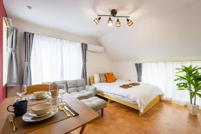 a bedroom with a bed and a table and a couch at Sakura Court Ebisu 502 in Tokyo