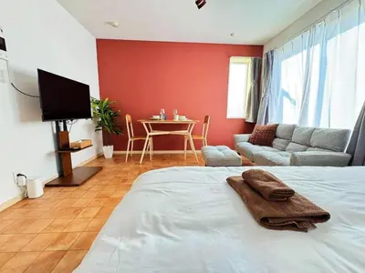 a bedroom with a bed and a couch and a table at Sakura Court Ebisu 502 in Tokyo