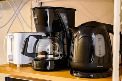 a coffee maker sitting on top of a shelf at Sakura Court Ebisu 502 in Tokyo