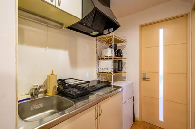 a kitchen with a sink and a counter top at Sakura Court Ebisu 502 in Tokyo