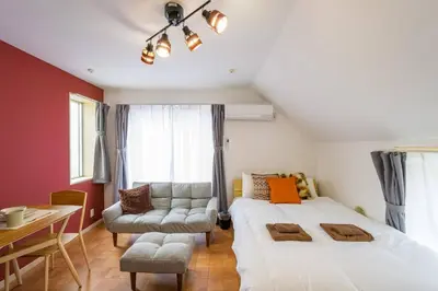 a bedroom with a bed and a couch and a table at Sakura Court Ebisu 502 in Tokyo