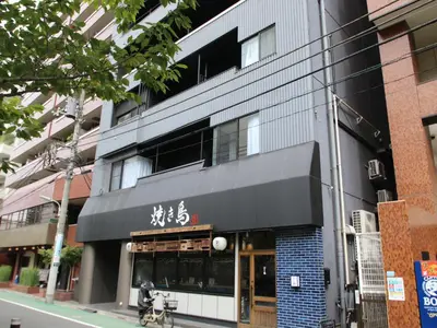 a building with writing on the side of it at Cassyta Gotanda Zeko-Residence in Tokyo