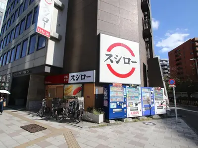 a building with signs on the side of it at Cassyta Gotanda Zeko-Residence in Tokyo