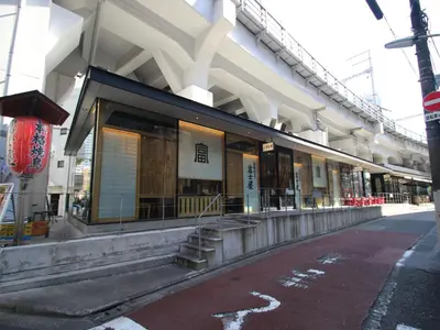 a building on a street next to a road at Cassyta Gotanda Zeko-Residence in Tokyo