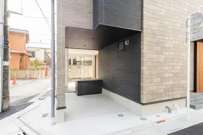 a brick building with a black wall at Jack of clubs inn in Tokyo