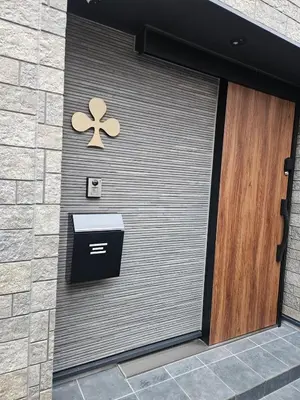 a metal garage door with a flower on it at Jack of clubs inn in Tokyo