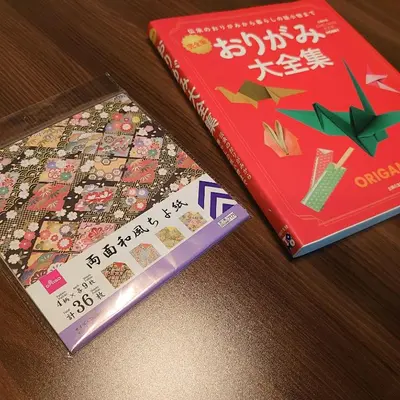 two books sitting on a table next to a book at Komone House in Tokyo