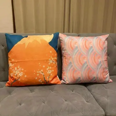 two pillows sitting on top of a couch at Komone House in Tokyo