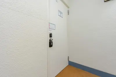 a locker room with a door with signs on the wall at \u4e80\u67095\u4e01\u76ee301 in Tokyo