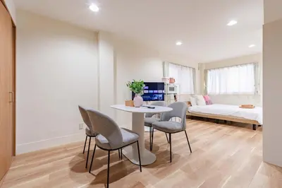 a room with a table and chairs and a bed at \u4e80\u67095\u4e01\u76ee301 in Tokyo