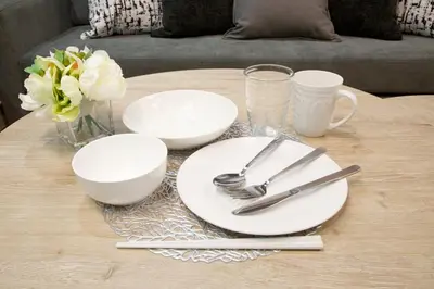 a table with white plates and utensils on it at Higashi Koiwa 6 Chome House 1F in Tokyo