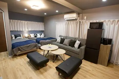 a bedroom with a bed and a couch and a table at Higashi Koiwa 6 Chome House 1F in Tokyo
