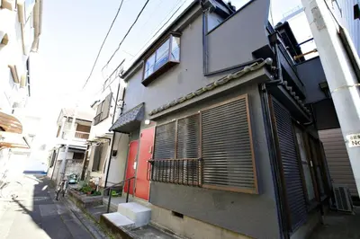 a building with blinds on the side of a street at Higashi Koiwa 6 Chome House 1F in Tokyo