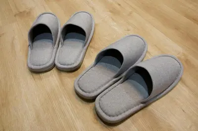 three pairs of slippers sitting on a wooden floor at Higashi Koiwa 6 Chome House 1F in Tokyo