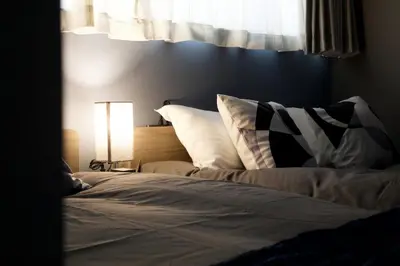 a bed with white sheets and pillows next to a window at Higashi Koiwa 6 Chome House 1F in Tokyo