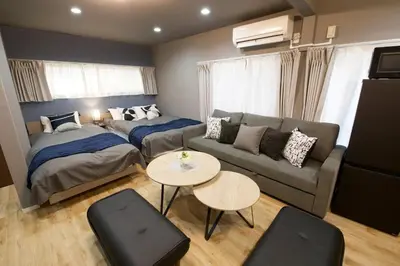 a living room with a couch and a bed at Higashi Koiwa 6 Chome House 1F in Tokyo