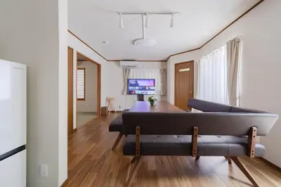 a bedroom with a bed and a living room at BF Stay Shinjukugyoen in Tokyo