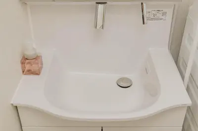 a bathroom with a white sink in a room at BF Stay Shinjukugyoen in Tokyo