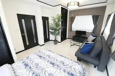 a living room with a couch and a bed in it at \u30bd\u30ec\u30a4\u30e6\u30cf\u30a6\u30b9\u897f\u845b\u897f in Tokyo