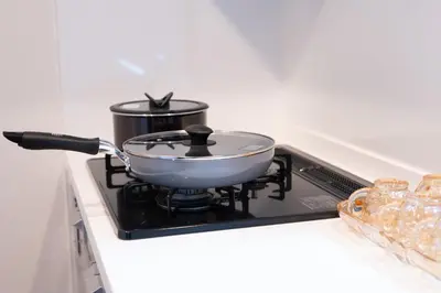 a pan on a stove with a pot on it at Sunbright Asakusa 201 in Tokyo