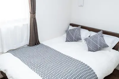 a bed with two pillows on it in a room at Sunbright Asakusa 201 in Tokyo
