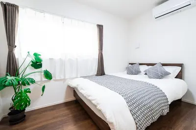 a bedroom with a bed and a window at Sunbright Asakusa 201 in Tokyo
