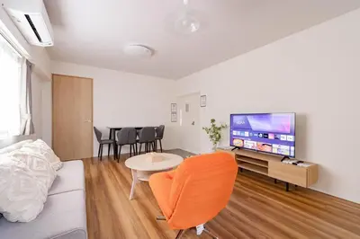a living room with a couch and a flat screen tv at \u4e80\u67095\u4e01\u76ee401 in Tokyo