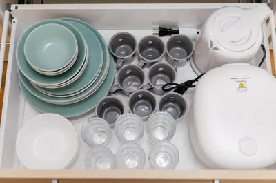 a drawer full of dishes and plates and a blender at \u4e80\u67095\u4e01\u76ee401 in Tokyo