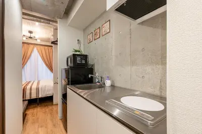 a bathroom with a sink and a kitchen with a bed at -Centray Okachimachi 102- 1 minute to Akihabara Station and Ueno Station without transfers! in Tokyo
