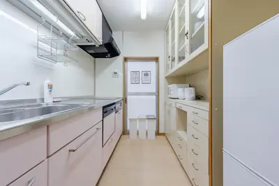 a kitchen with white cabinets and a sink at \u4e80\u67095\u4e01\u76ee201 in Tokyo