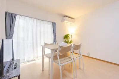a white table and chairs in a room with a window at \u4e80\u67095\u4e01\u76ee201 in Tokyo