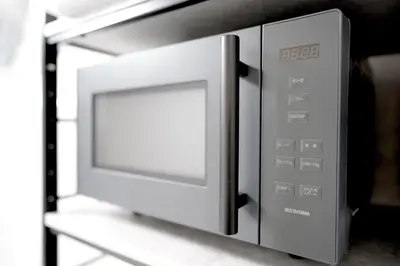 a microwave oven sitting on top of a shelf at 11AM out, Asakusa Base, 3F Skytree-View Rooms, Projector Mini Theater in Tokyo