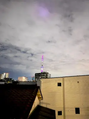 a view of a tv tower on top of a building at 11AM out, Asakusa Base, 3F Skytree-View Rooms, Projector Mini Theater in Tokyo