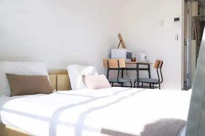a bedroom with a bed and a table and chairs at Ikebukuro 303 - Twin Room in Tokyo