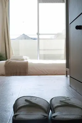 a room with two stools on the floor in front of a window at Ikebukuro 303 - Twin Room in Tokyo