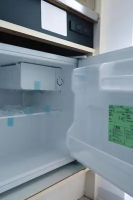 an empty refrigerator with its door open with a sticker on it at Ikebukuro 303 - Twin Room in Tokyo