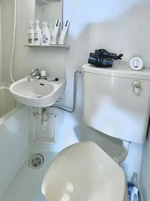 a small bathroom with a toilet and a sink at Ikebukuro 303 - Twin Room in Tokyo