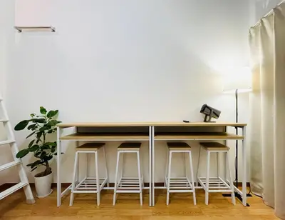a kitchen with a bar with stools around it at Alo BnB 15 - Near TABATA, IKEBUKURO, SHINJUKU, UENO in Tokyo