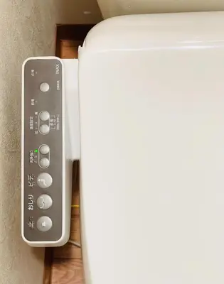 a remote control next to a white refrigerator at Alo BnB 15 - Near TABATA, IKEBUKURO, SHINJUKU, UENO in Tokyo