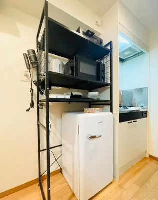 a kitchen with a white refrigerator in a room at Alo BnB 15 - Near TABATA, IKEBUKURO, SHINJUKU, UENO in Tokyo