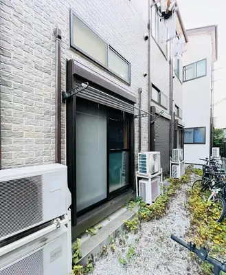 a brick building with a window and a heater at Alo BnB 15 - Near TABATA, IKEBUKURO, SHINJUKU, UENO in Tokyo