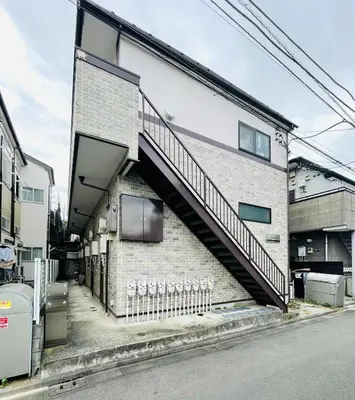 a staircase on the side of a brick building at Alo BnB 15 - Near TABATA, IKEBUKURO, SHINJUKU, UENO in Tokyo