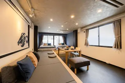 a living room with a couch and a table at ZENBASE Ryogoku in Tokyo
