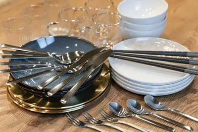 a table with plates and silverware on a table at ZENBASE Ryogoku in Tokyo
