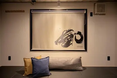 a black and white picture of a motorcycle on a wall at ZENBASE Ryogoku in Tokyo