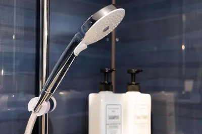 a toothbrush and a bottle of soap on a counter at ZENBASE Ryogoku in Tokyo