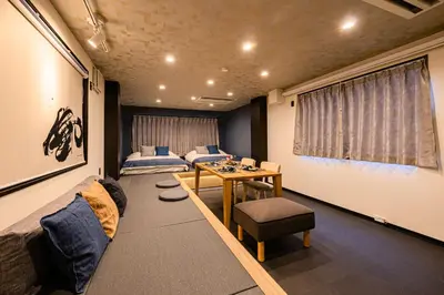 a living room with a couch and a table at ZENBASE Ryogoku in Tokyo